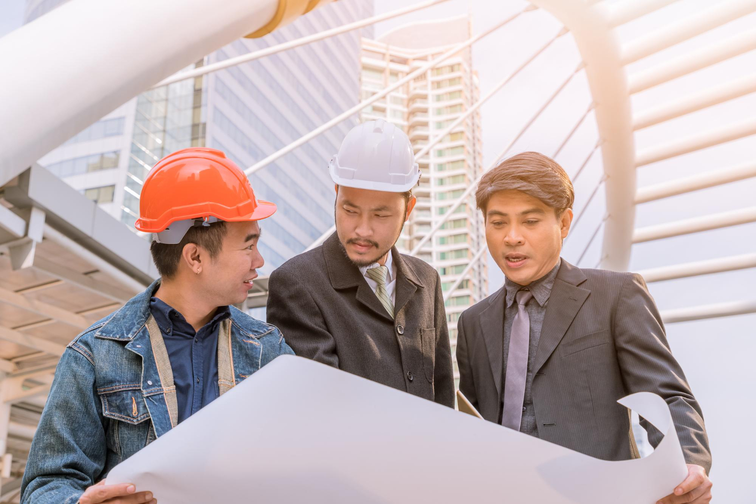manager-meeting-with-engineer-outdoor-site-discuss-plan-looking-blueprint